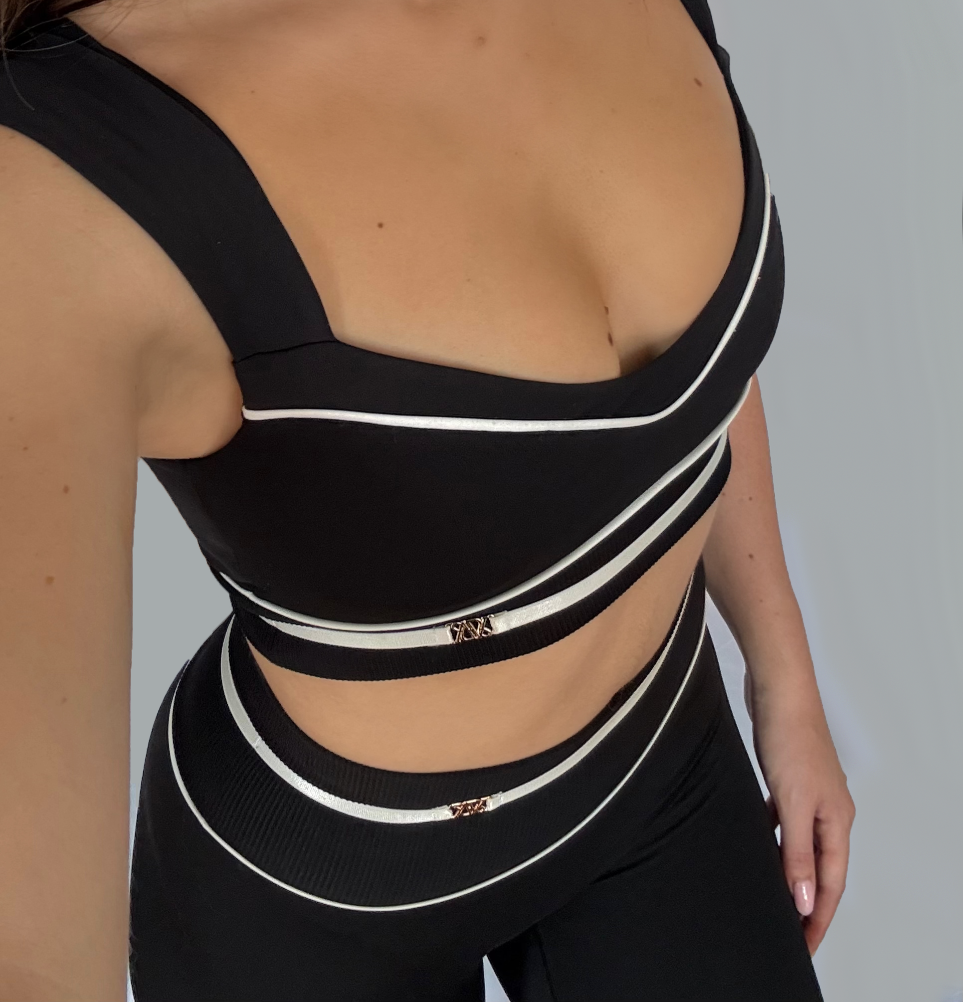 Black and white striped top worn by a person on a plain background